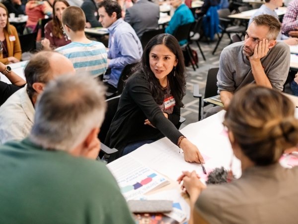 People talking around a table at the local-news gathering.