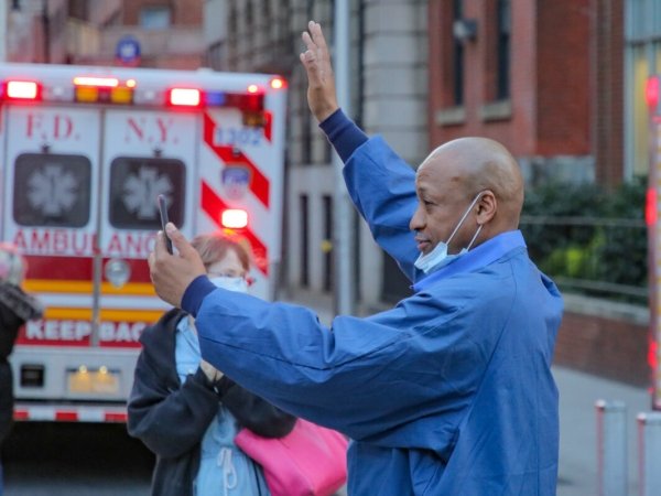 Health-care worker in NYC near an ambulance