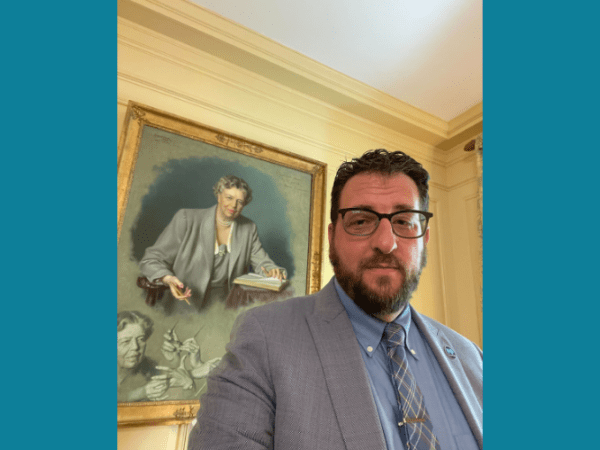 Free Press Co-CEO Craig Aaron in front of the Eleanor Roosevelt portrait at the White House