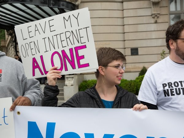 Net Neutrality activist holding sign reading "Leave my open internet alone"