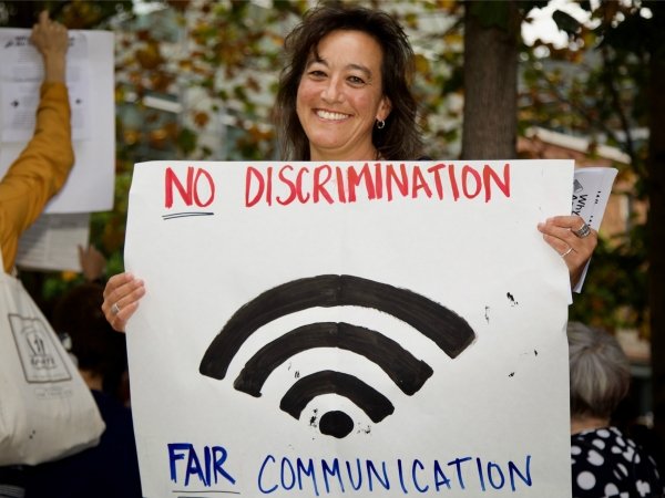 Activist holding "No discrimination/fair communication" poster