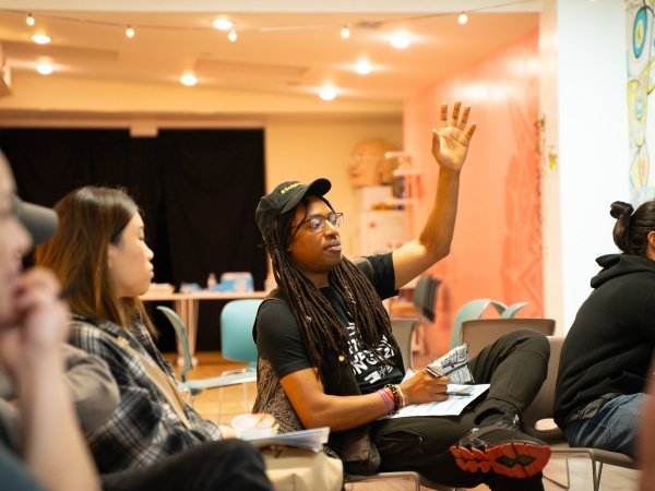 A man at Free Press' community event in Pilsen, Chicago, raises his hand