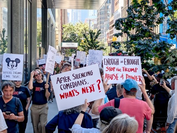 Activists holding signs at a pro-Jimmy Kimmel protest in NYC