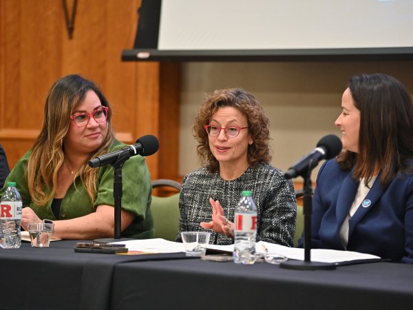 Free Press' Vanessa Maria Graber and Jessica J. González sitting on either side of FCC Commissioner Anna Gomez