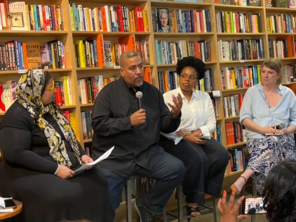 Free Press’ Joseph Torres (second from left) sitting in Solid State Books with three other people