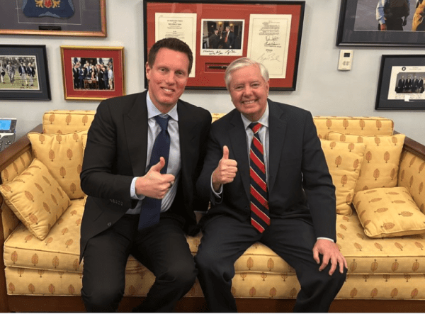 Paramount Skydance CEO David Ellison sitting with Sen. Lindsey Graham