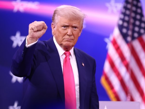 Trump holding a fist up at the 2025 Conservative Political Action Conference