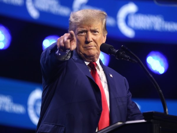 Trump pointing a finger on the stage of the 2023 Turning Point Action Conference
