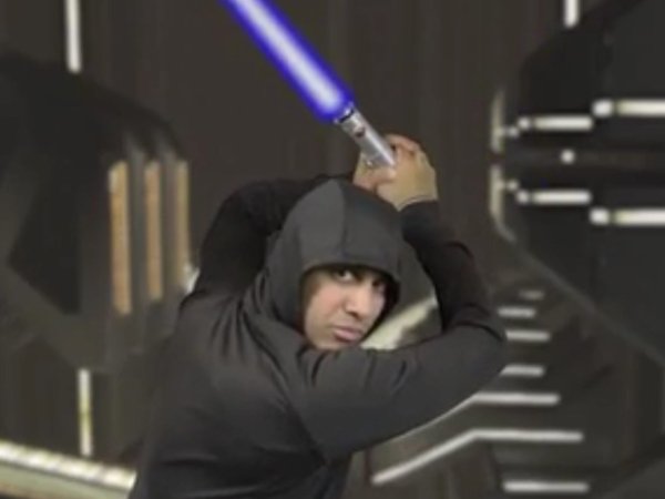 FCC Chairman Ajit Pai holding a Star Wars lightsaber