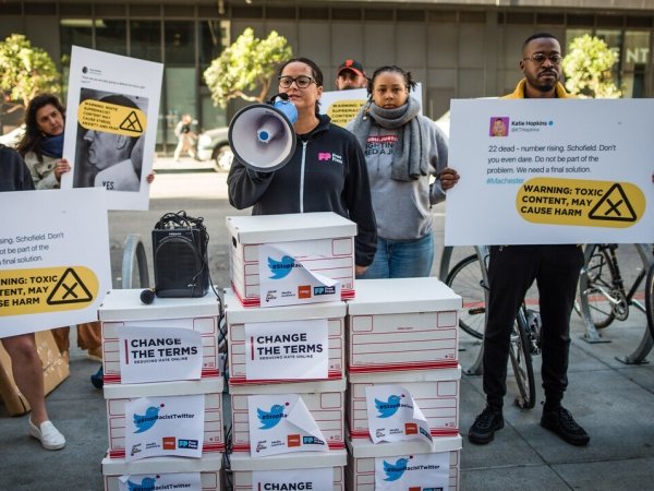 Free Press Action's Jessica J. Gonzalez speaks into a megaphone at a protest outside Twitter headquarters.