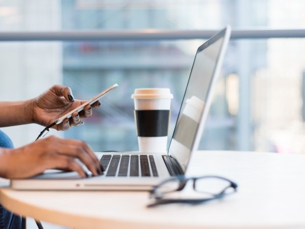 Person working at laptop (only hands and laptop visible)