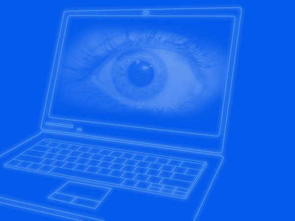 An open laptop with a giant eyeball on its screen.