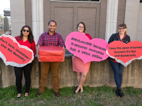 Four Free Press Action staffers holding valentines to Net Neutrality