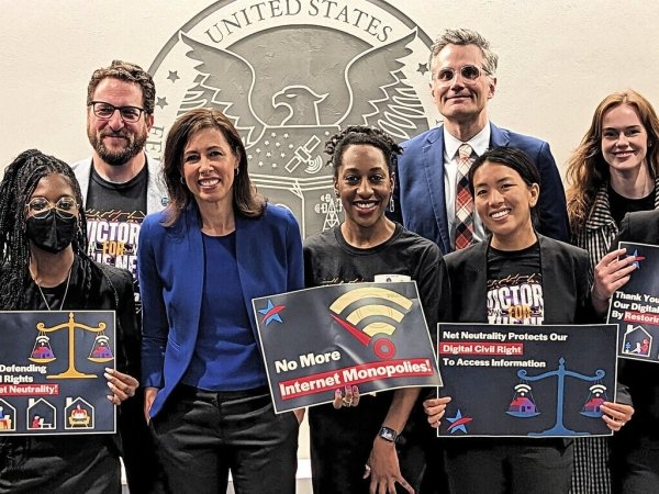Free Press staffers and allies with FCC Chairwoman Jessica Rosenworcel (in blue) the day the agency voted to restore Net Neutrality and reinstate its Title II authority