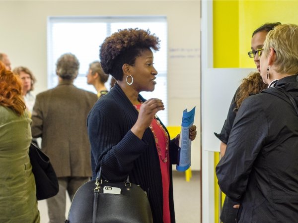 Woman in profile talking to two other people