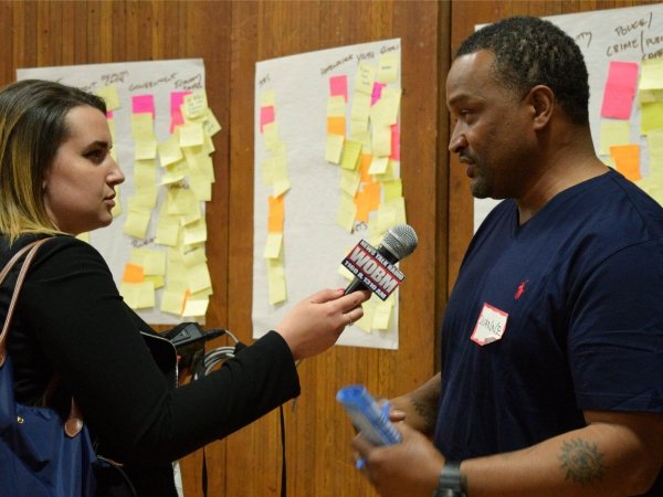A reporter interviewing a man at a News Voices event.