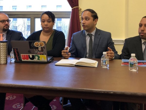 Four panelists participating in this anti-merger discussion
