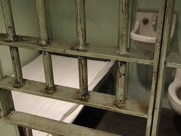 Prison cell with a bed, sink and toilet