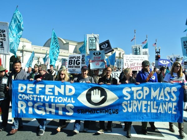 Anti-surveillance activists holding banner