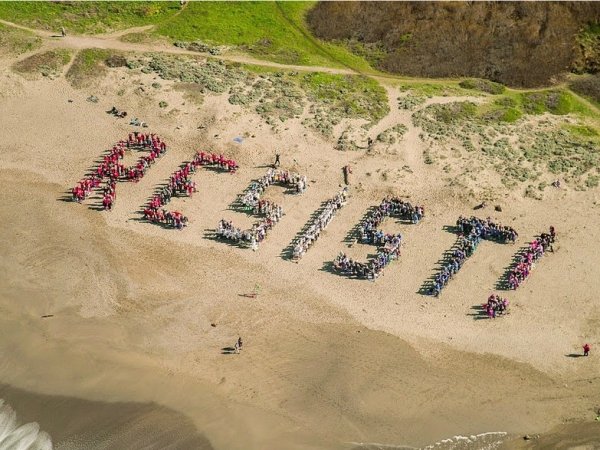 The word "resist" spelled out on a beach
