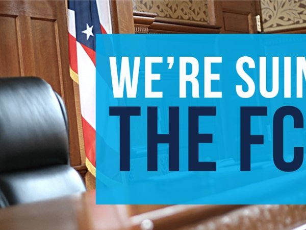 The text "We're suing the FCC" juxtaposed over judge's chair and bench