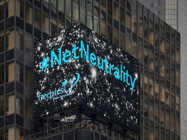 Times Square electronic billboard displaying the words "Net Neutrality" + the Free Press logo