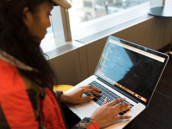 person types on computer