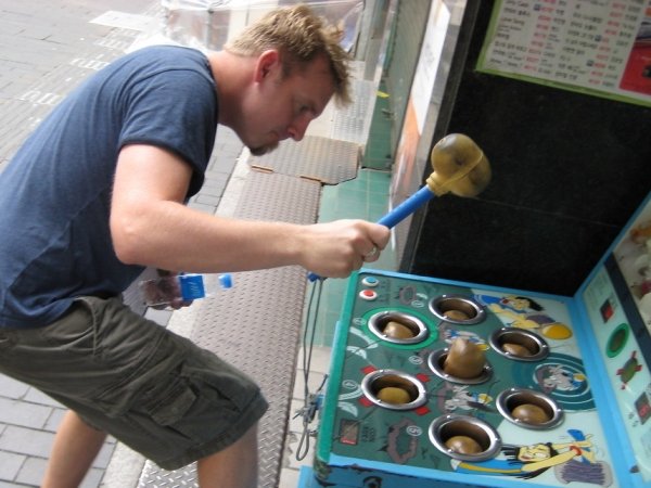 Man playing Whack-a-Mole