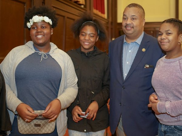 Five young women with Rep. Donald Payne Jr.