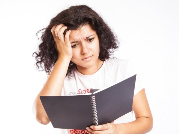 Woman reading with confused expression