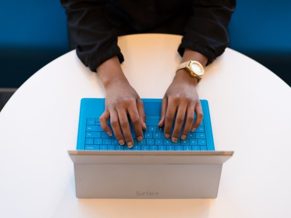 Hands typing on laptop