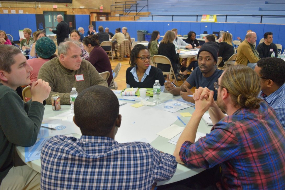 Community members in New Jersey sitting around a table discuss ways to strengthen local journalism.