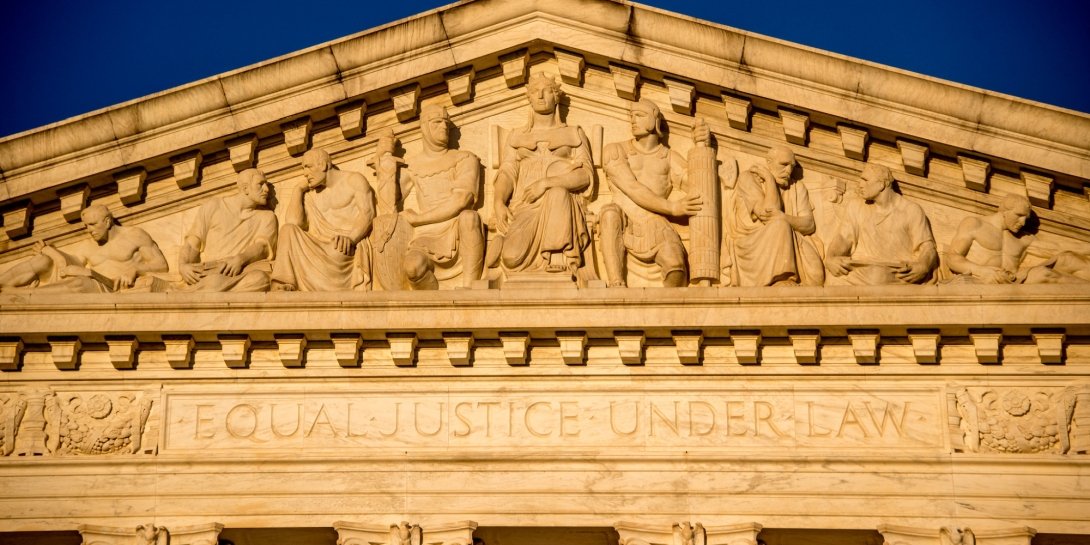 The top of the Supreme Court building, featuring statues and the phrase "Equal Justice Under Law"