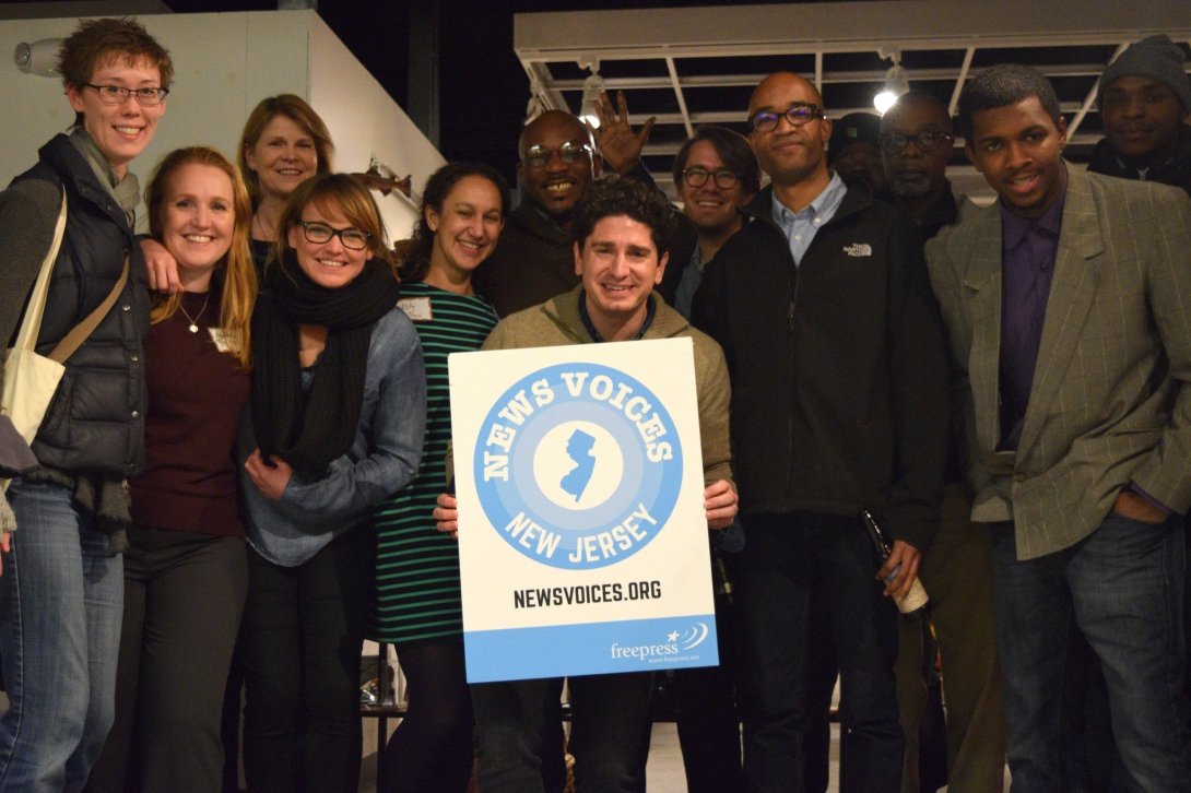 Group of people holding a News Voices: New Jersey sign