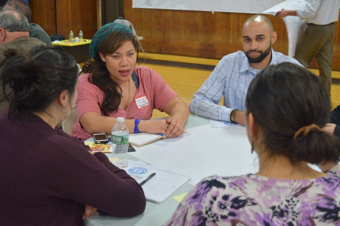 Woman talking at table with three other people
