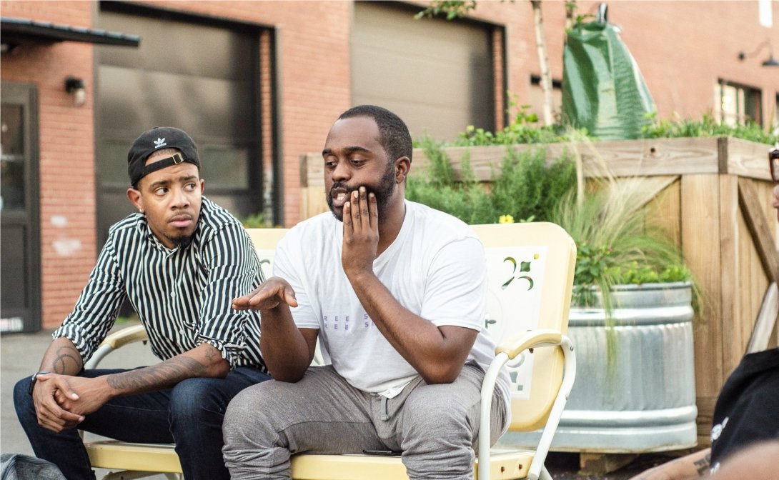 Two men sitting side by side