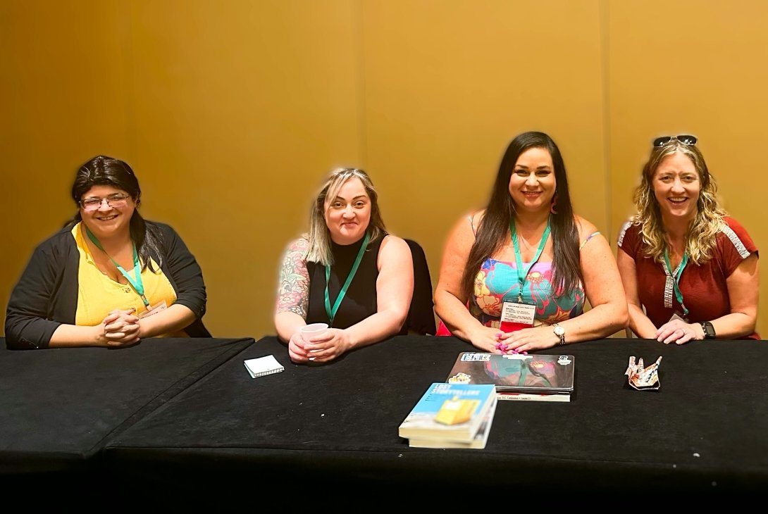 Free Press' Vanessa Maria Graber and other advocates sitting at a table at the Association in Journalism and Mass Communication conference