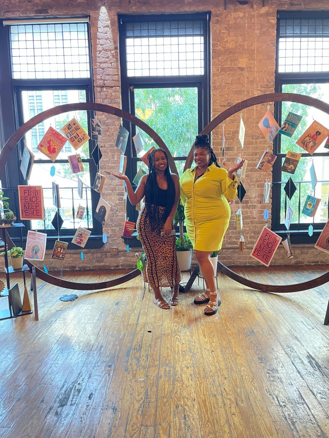 Diamond Hardiman and Venneikia Williams in front of the Black Future Newsstand exhibit, which explores Black liberation, at Afrotech