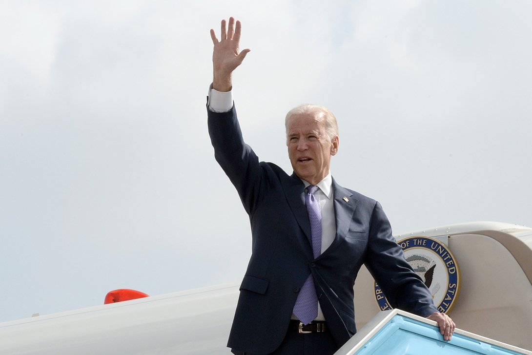 President Joe Biden waves before boarding a plane