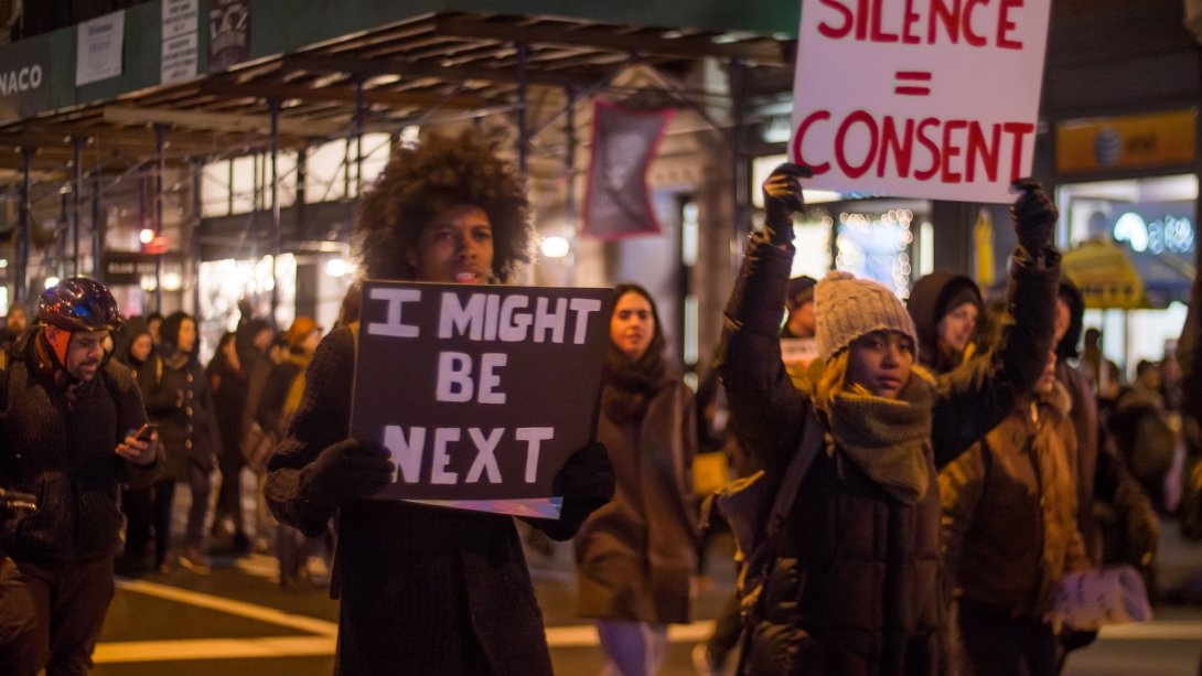 Black Lives Matter protest, with activists holding signs reading "I might be next" and "Silence = consent"