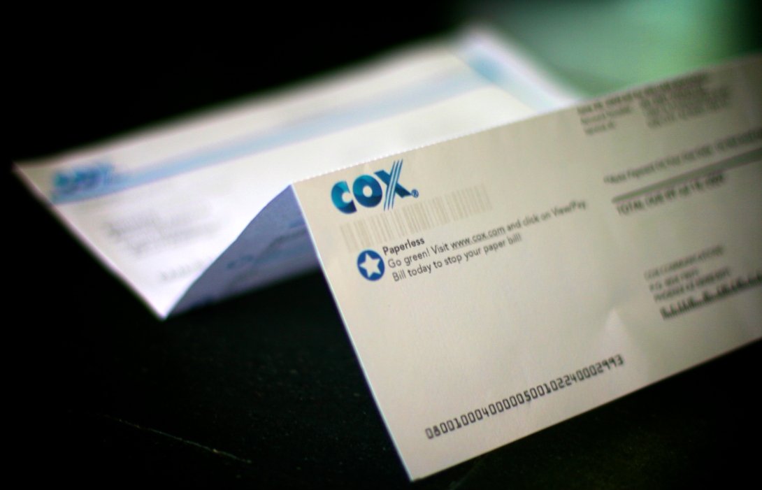 A Cox cable bill open on a table