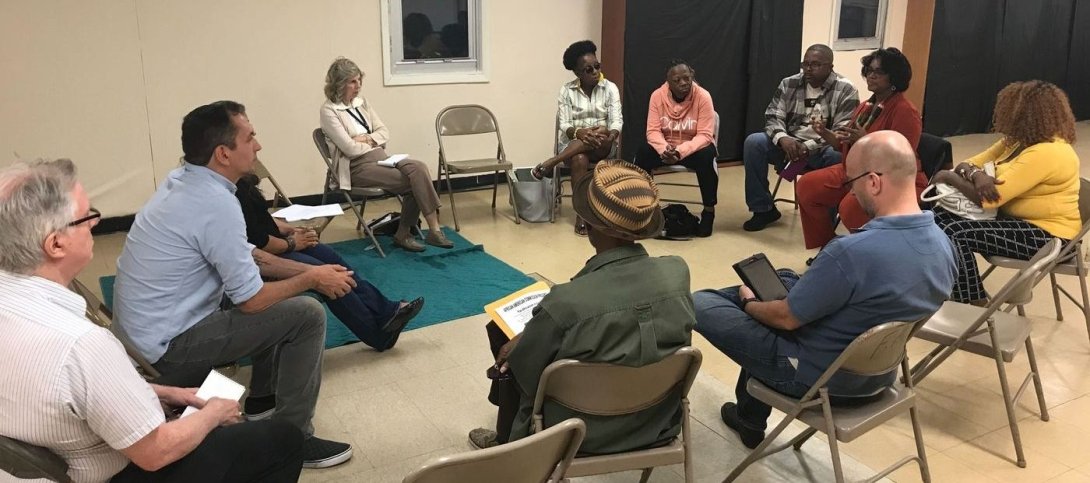 Residents and reporters at an event in Camden