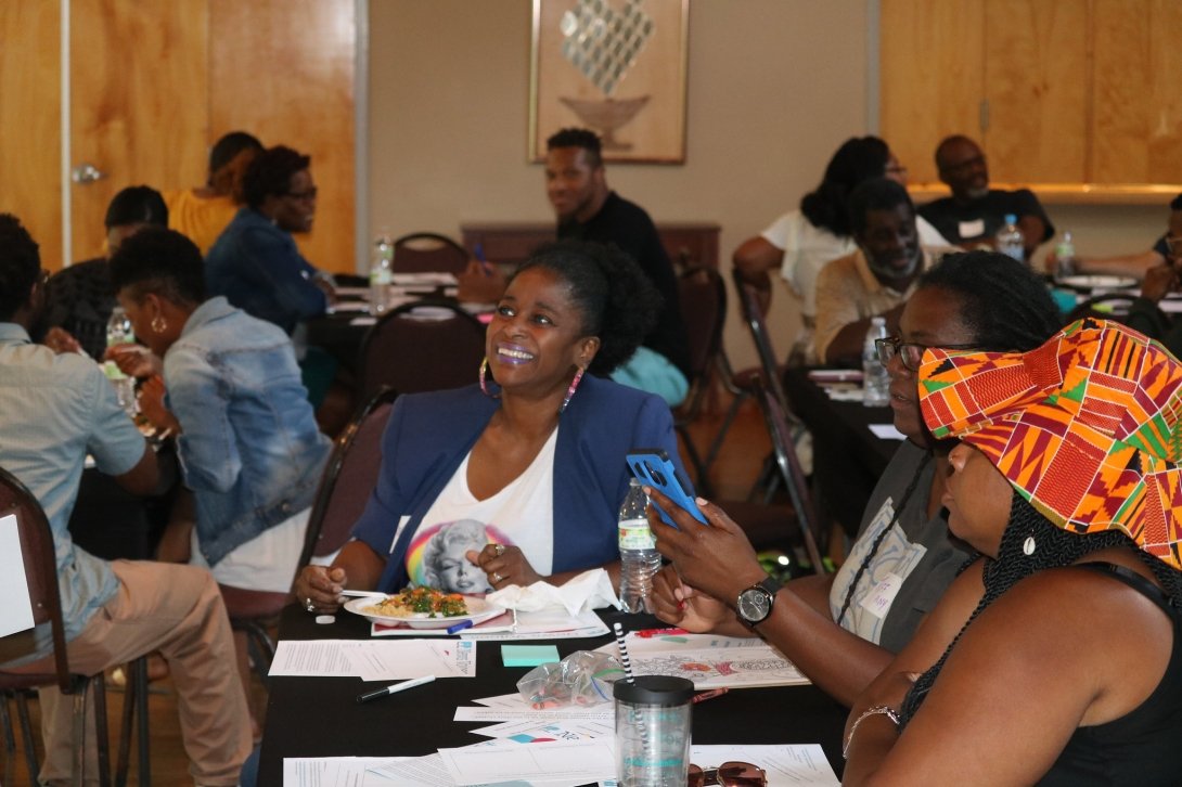 Woman smiling at table with other people