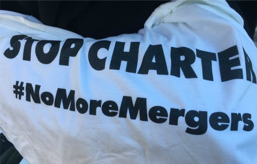 T-shirt reading "Stop Charter / #NoMoreMergers