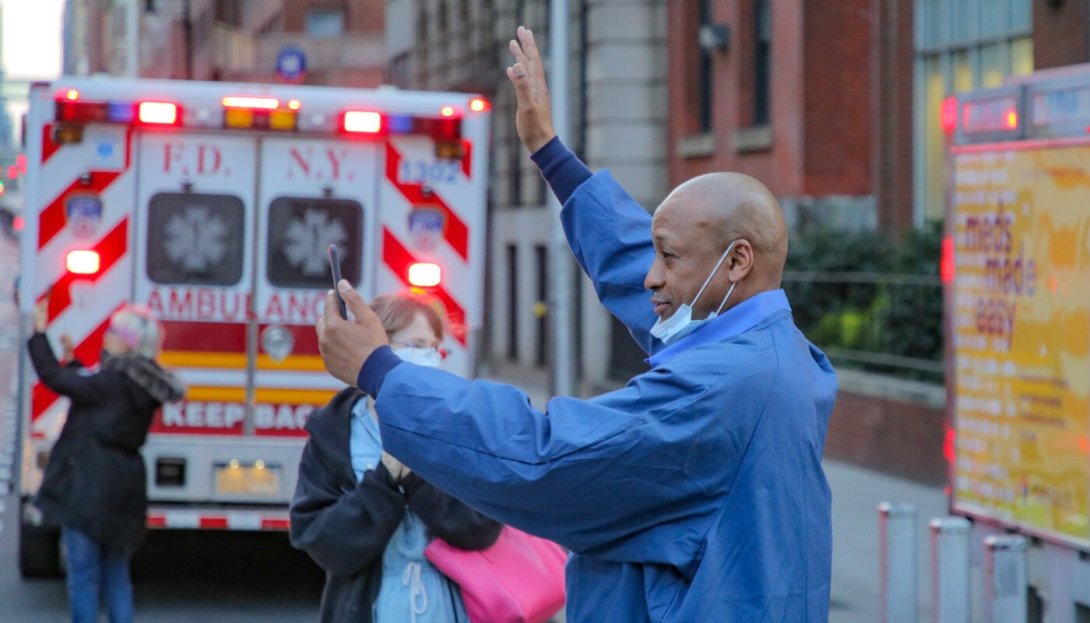 Health-care worker in NYC near an ambulance