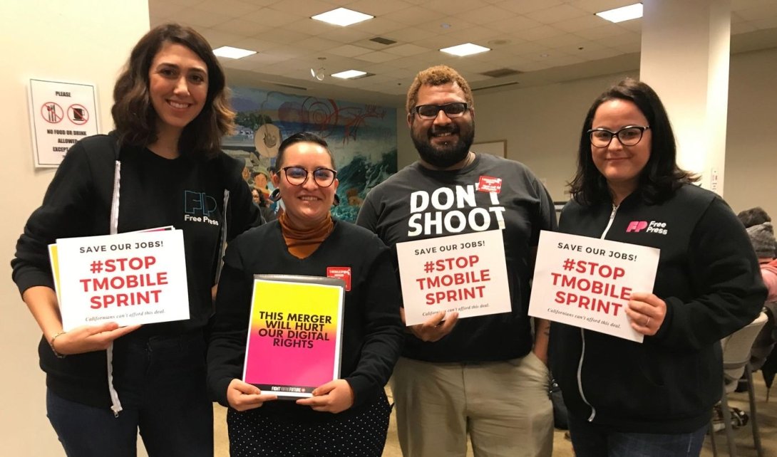Advocates from Free Press Action and other groups holding signs opposing the merger