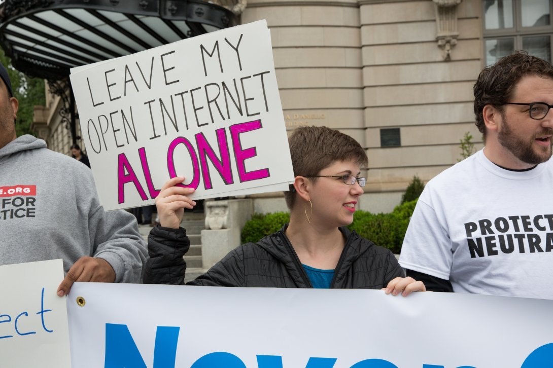 Net Neutrality activist holding sign reading "Leave my open internet alone"