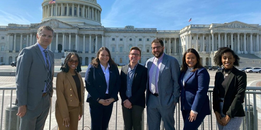 Free Press Action staffers standing in front of the U.S. Capitol