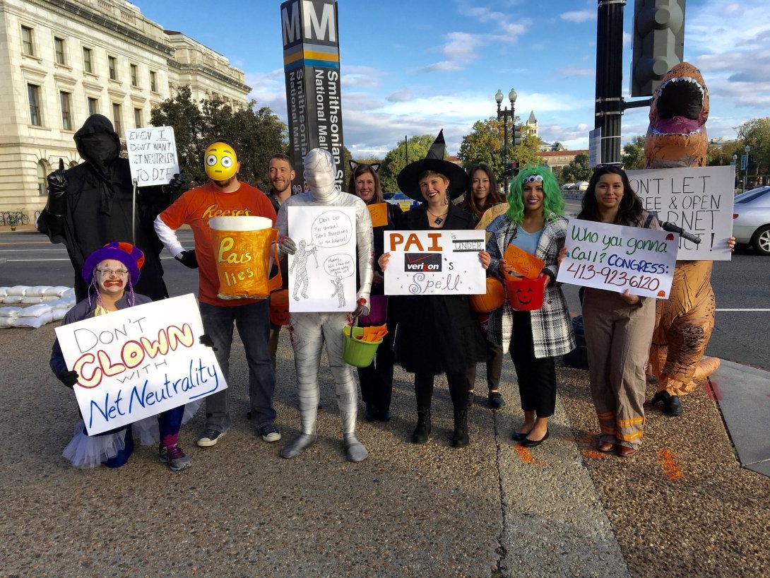 People dressed up as a clown, mummy, witch, Godzilla and other creatures