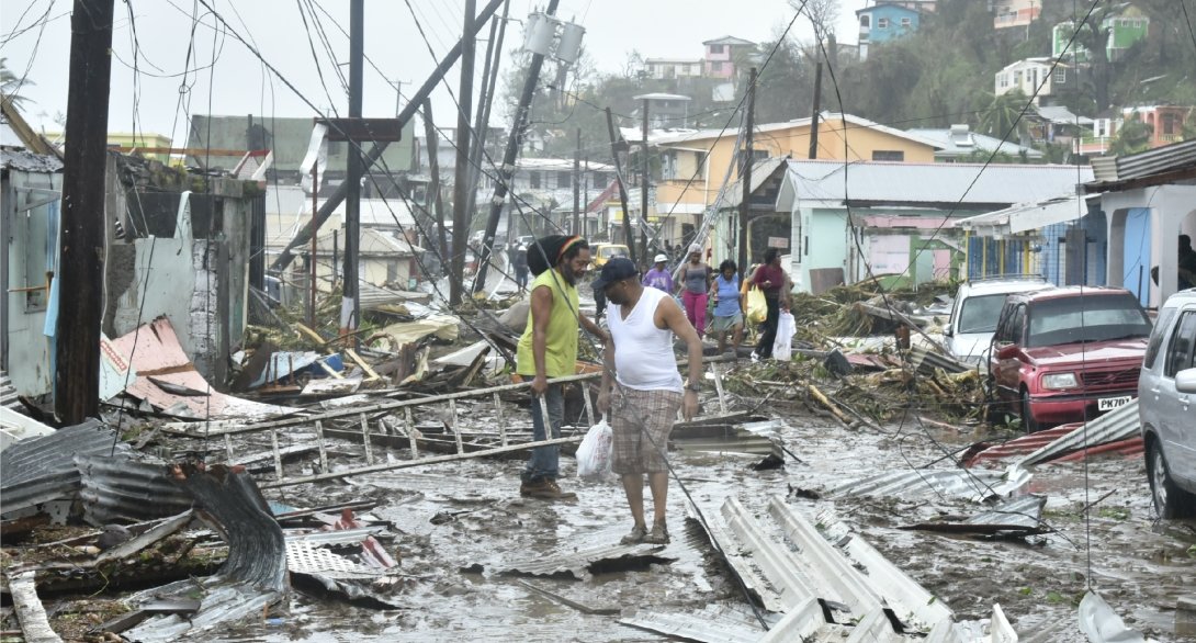 Residents standing amid the devastation in Puerto Rico